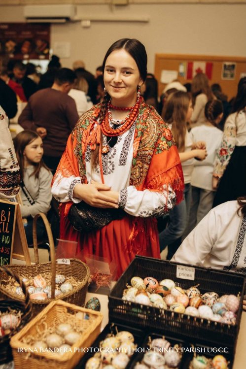 Olha Lesiv in Ukrainian folk dress at her pysanky table